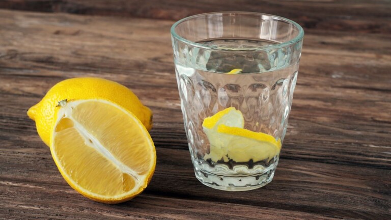 Cut lemon and a glass of lemon water