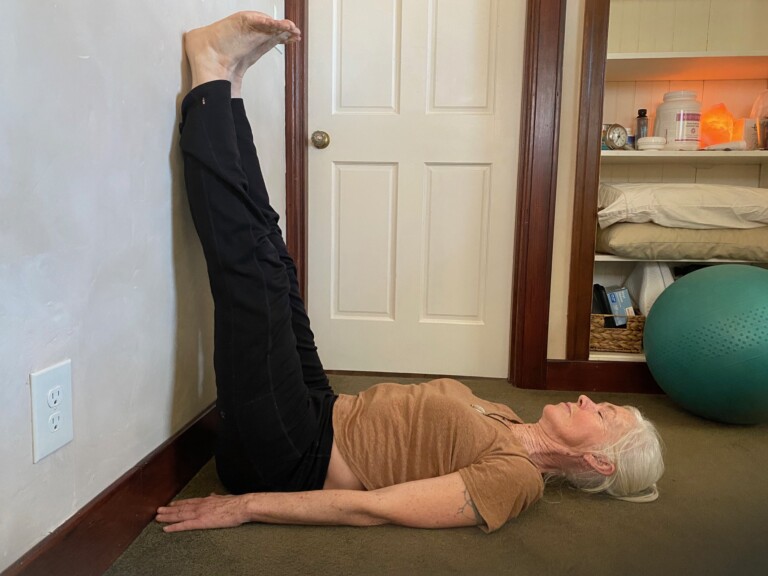 Feet-up-against-the-wall relieves back pain and kyphosis